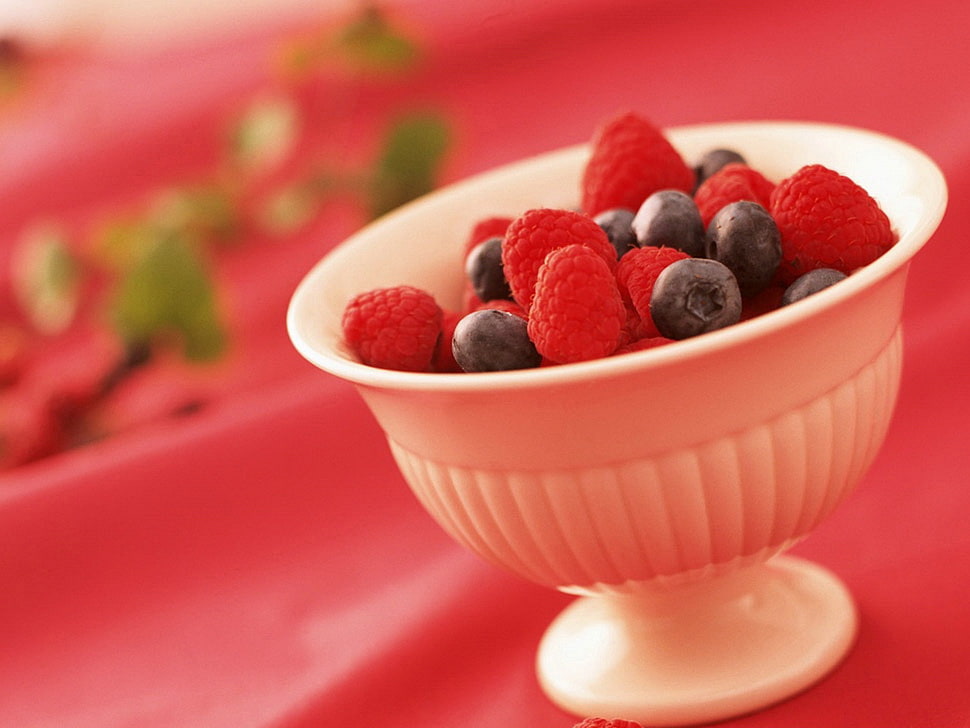 raspberries and blueberries on white ceramic bowl HD wallpaper